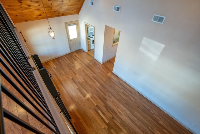 interior space featuring lofted ceiling, wooden ceiling, and light wood-type flooring