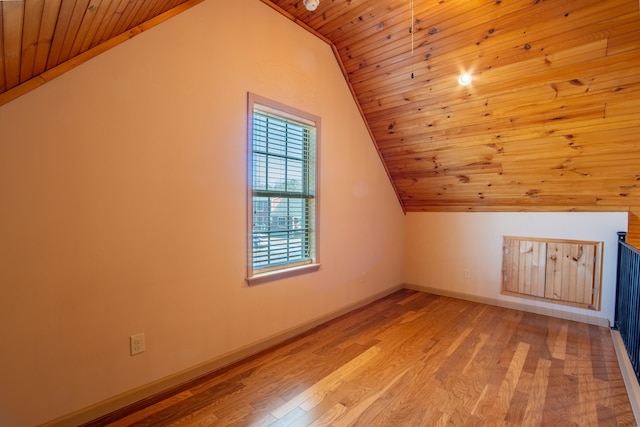 additional living space featuring lofted ceiling, wooden ceiling, and light hardwood / wood-style floors