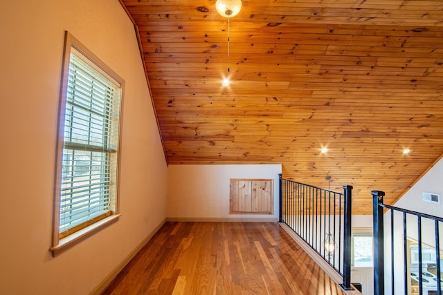 bonus room featuring light hardwood / wood-style flooring, wood ceiling, and vaulted ceiling