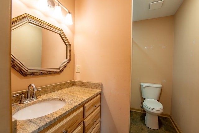 bathroom featuring vanity and toilet