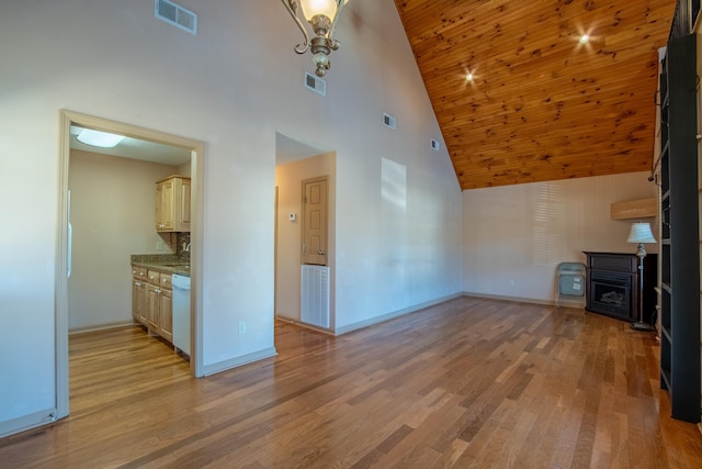 unfurnished living room with high vaulted ceiling and light wood-type flooring