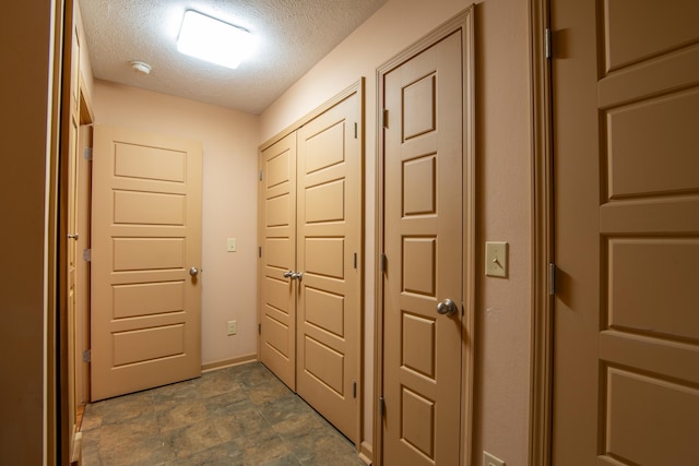 hallway featuring a textured ceiling