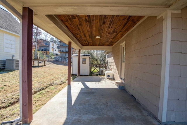 view of patio / terrace featuring central AC and a storage unit