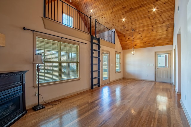 unfurnished living room featuring wood-type flooring, high vaulted ceiling, and wooden ceiling