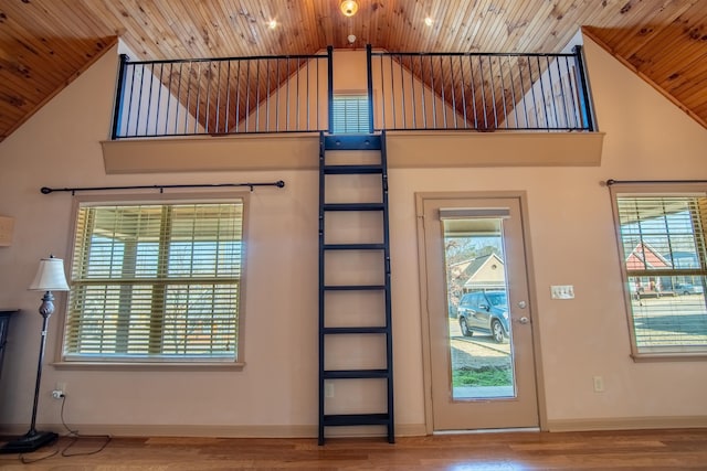 entryway featuring hardwood / wood-style floors, wood ceiling, and high vaulted ceiling