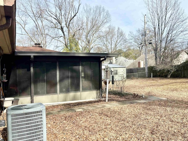 view of side of home featuring central AC unit and a sunroom