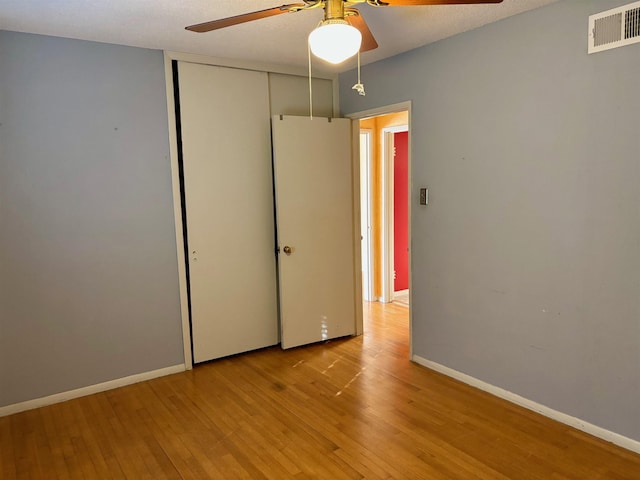 496 Chalmers Rd, Memphis, TN 38120 - unfurnished bedroom featuring visible vents, a closet, baseboards, light wood-type flooring, and a ceiling fan