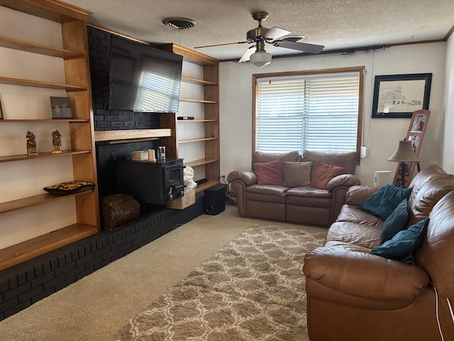 carpeted living room with ceiling fan, a textured ceiling, and a wood stove