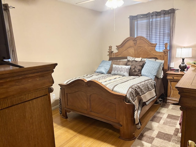 bedroom with light hardwood / wood-style flooring and ceiling fan