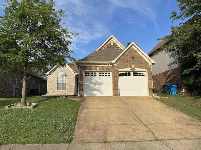 view of front of house with a garage and a front lawn