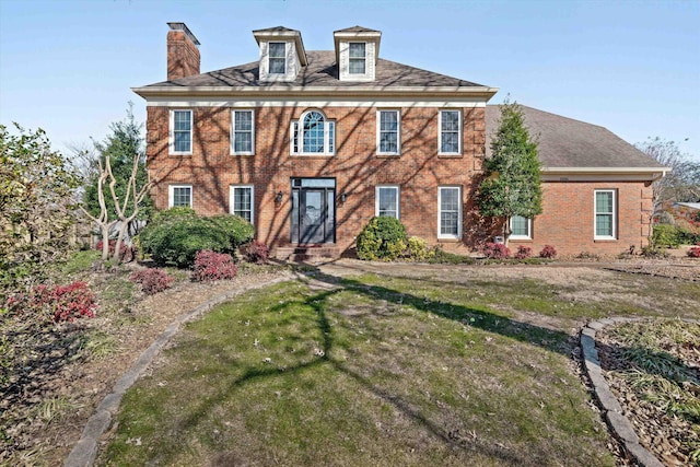 colonial home with a front lawn