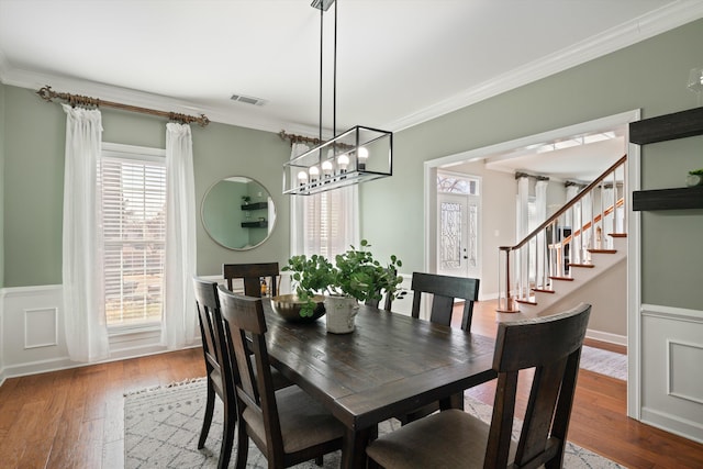 dining room featuring wood-type flooring and ornamental molding