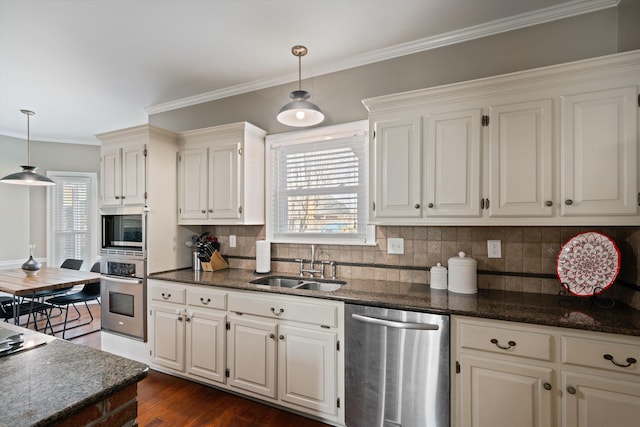 kitchen with stainless steel appliances, sink, pendant lighting, and white cabinets