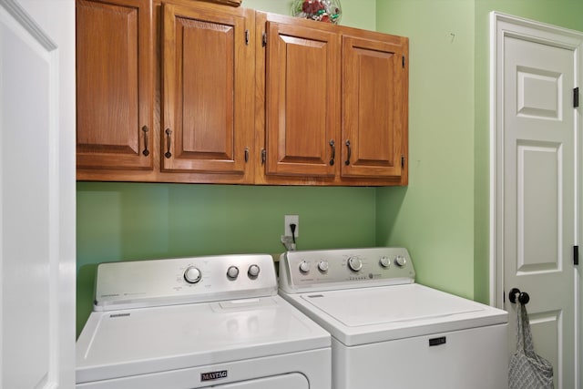 laundry area featuring cabinets and washing machine and dryer