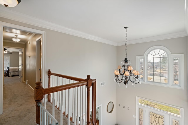 details featuring an inviting chandelier, ornamental molding, and carpet