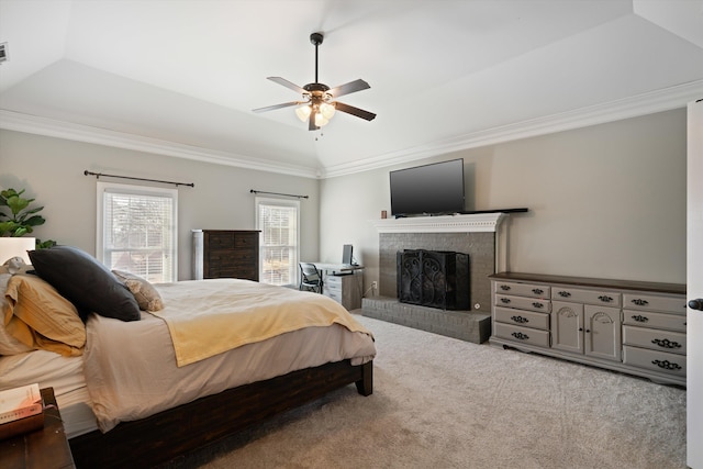 carpeted bedroom with a fireplace, ornamental molding, a raised ceiling, and vaulted ceiling