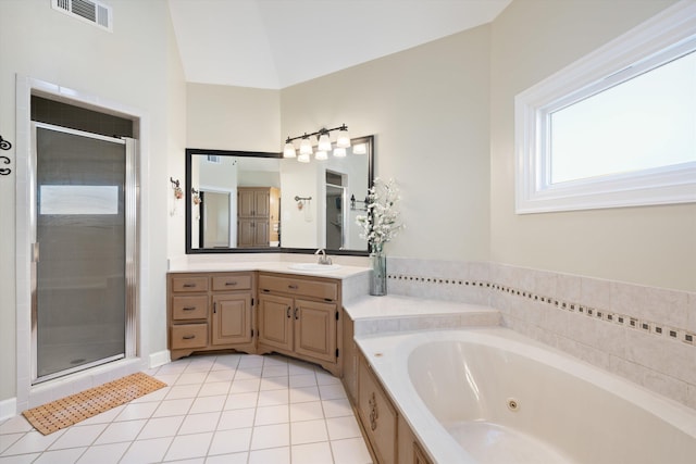 bathroom featuring vanity, tile patterned flooring, vaulted ceiling, and independent shower and bath