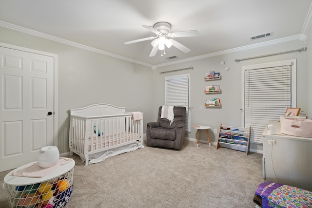 bedroom featuring light colored carpet, ornamental molding, and a crib