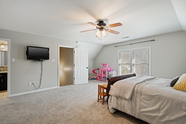 carpeted bedroom featuring lofted ceiling, sink, ceiling fan, and ensuite bathroom