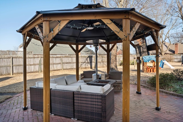 view of patio featuring a gazebo, an outdoor living space with a fire pit, and a playground