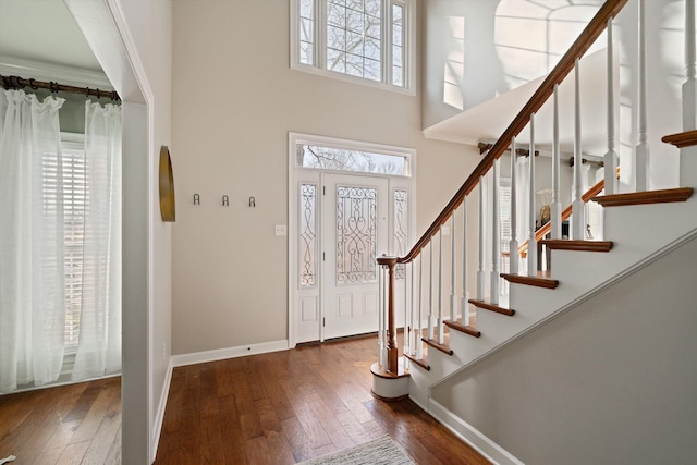 entrance foyer with a high ceiling and dark hardwood / wood-style flooring