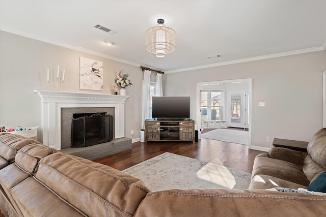 living room featuring dark wood-type flooring, a fireplace, and ornamental molding