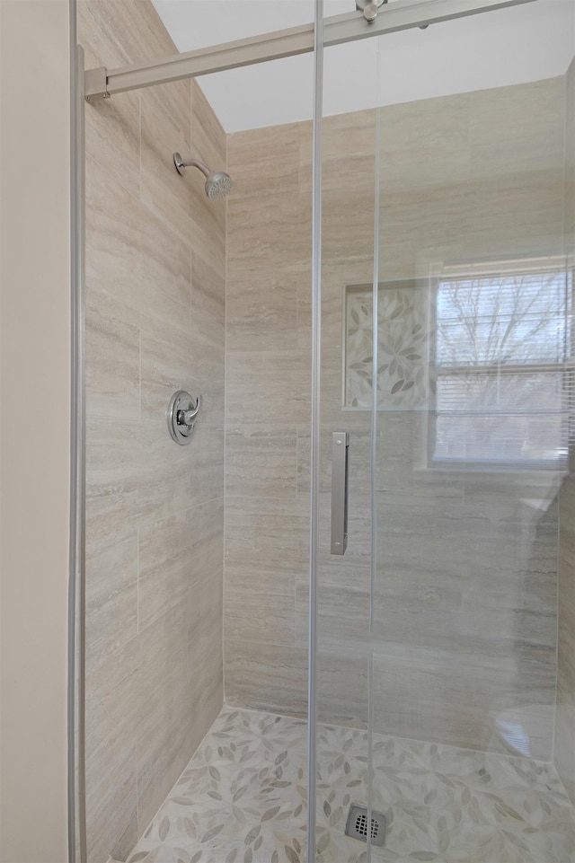 bathroom featuring a shower with door