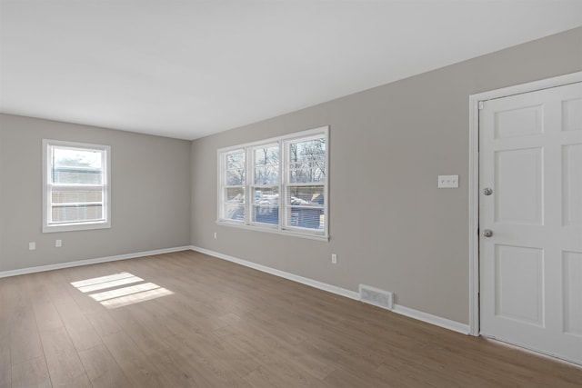 unfurnished room with hardwood / wood-style floors