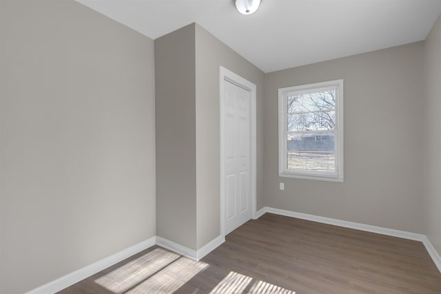 unfurnished bedroom with hardwood / wood-style flooring and a closet