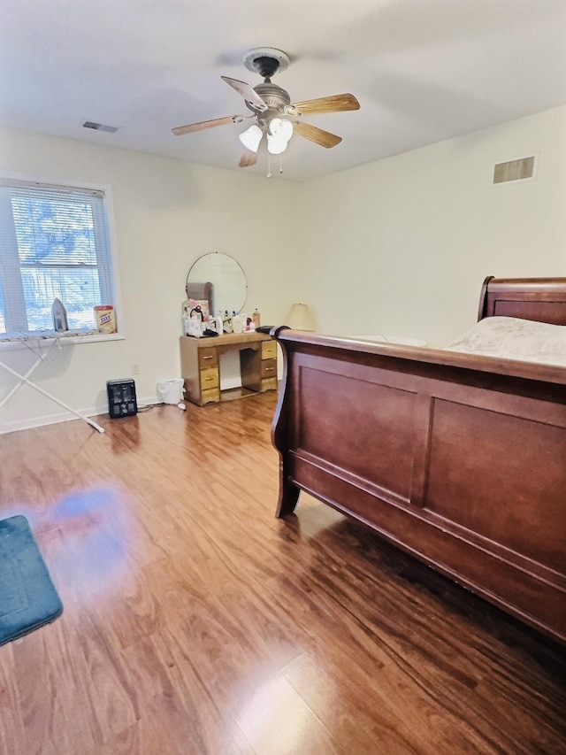 bedroom with hardwood / wood-style floors and ceiling fan