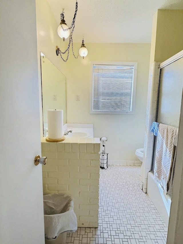 full bathroom featuring enclosed tub / shower combo, tile patterned floors, toilet, and vanity