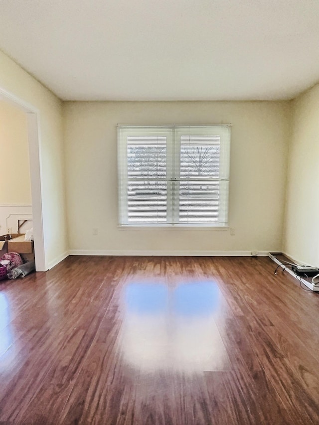 spare room featuring dark wood-type flooring