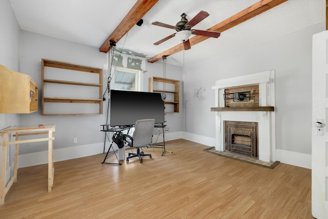 office with ceiling fan, a textured ceiling, beam ceiling, and light hardwood / wood-style flooring