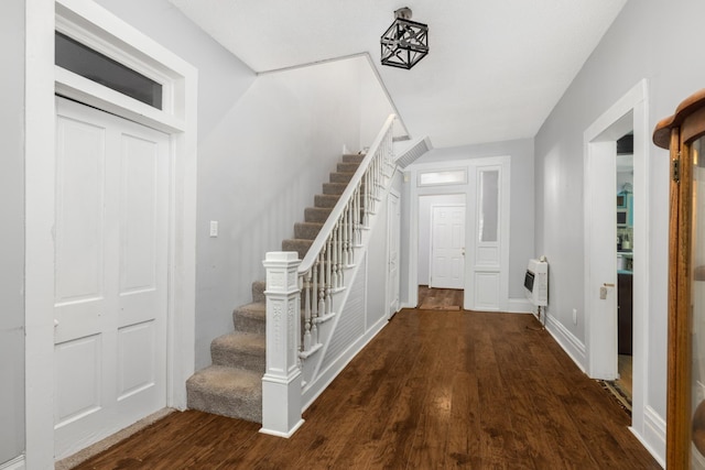 entryway with heating unit and dark wood-type flooring