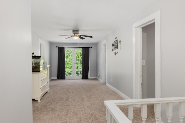 hall with light colored carpet