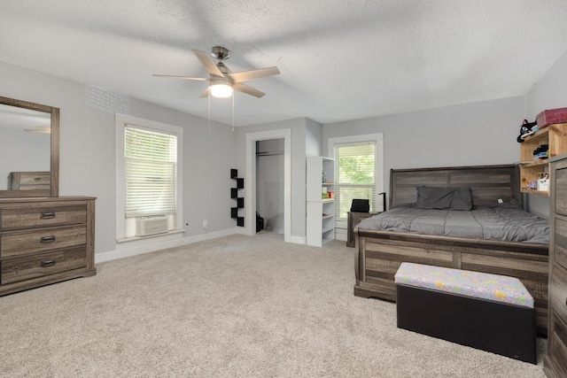 bedroom featuring cooling unit, ceiling fan, light carpet, and a textured ceiling