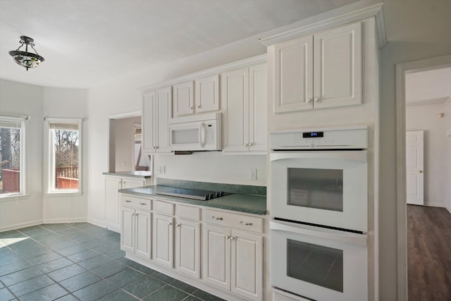 kitchen featuring white cabinetry and white appliances