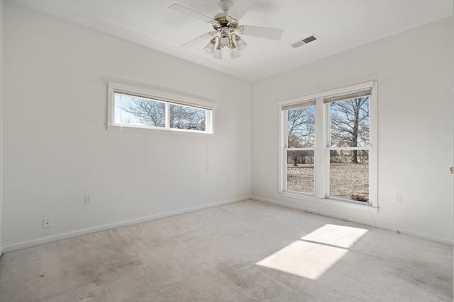 empty room featuring light carpet and ceiling fan