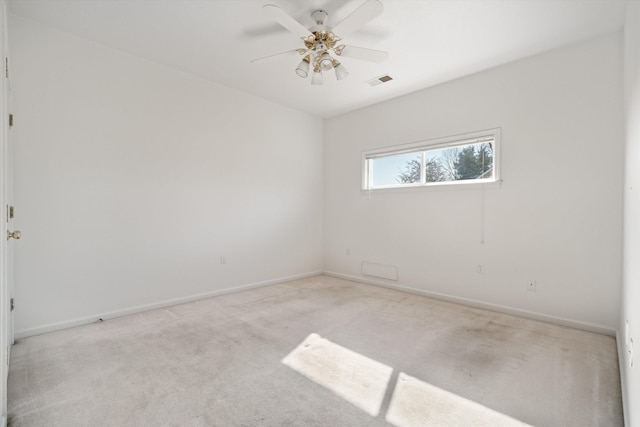 empty room with light colored carpet and ceiling fan