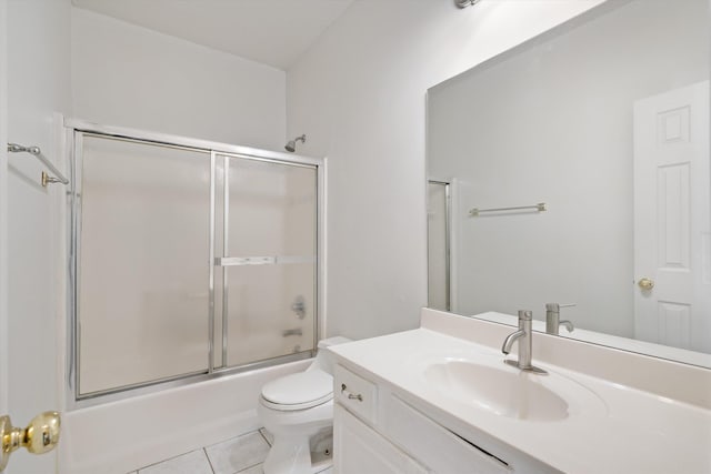 full bathroom featuring tile patterned flooring, vanity, shower / bath combination with glass door, and toilet