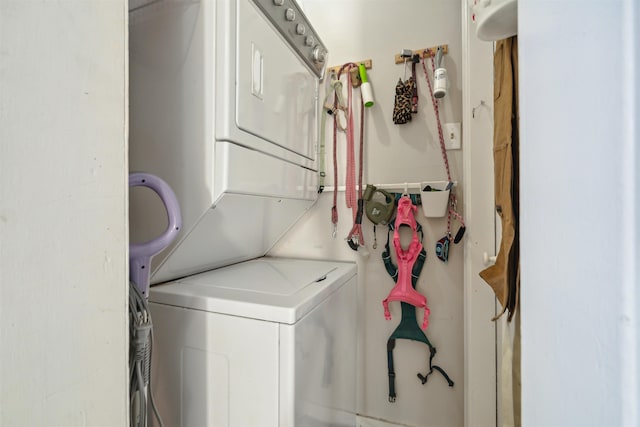 laundry room with stacked washer / dryer