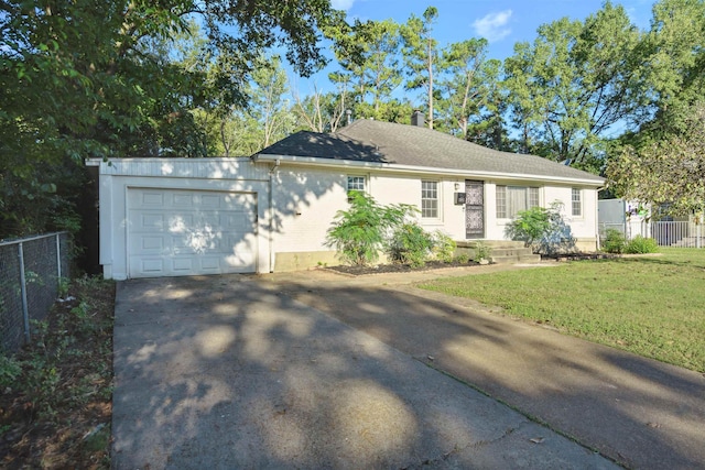 ranch-style home featuring a garage and a front lawn