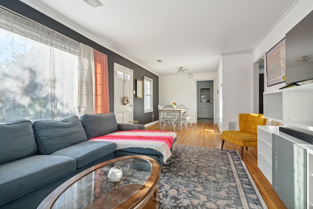 living room with hardwood / wood-style flooring and ornamental molding