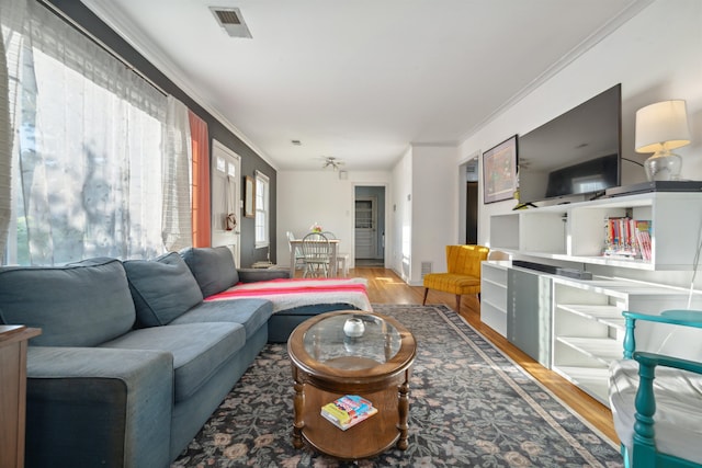 living room featuring crown molding and hardwood / wood-style floors