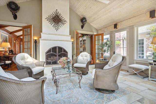 sunroom / solarium featuring wood ceiling, a large fireplace, and lofted ceiling