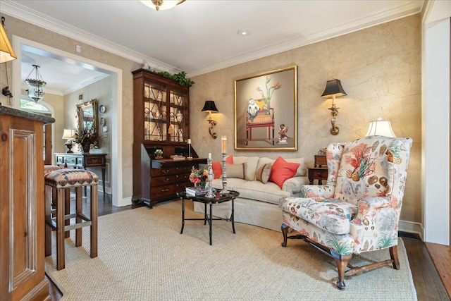 sitting room featuring ornamental molding and wood-type flooring