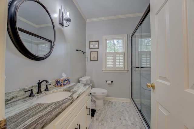 bathroom with vanity, crown molding, a shower with shower door, and toilet