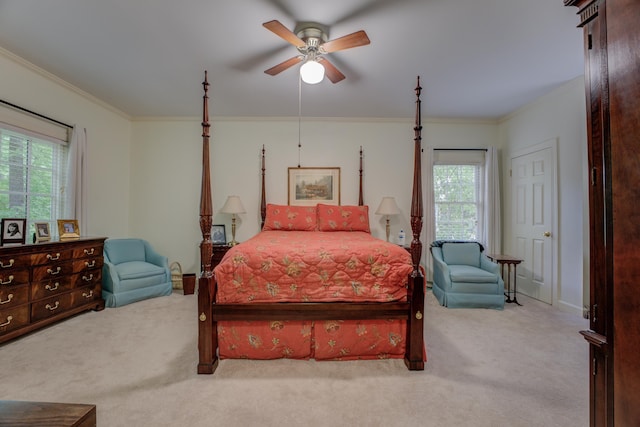 carpeted bedroom featuring crown molding and ceiling fan