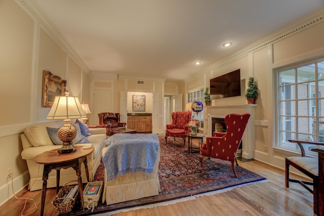 living room featuring hardwood / wood-style floors and ornamental molding