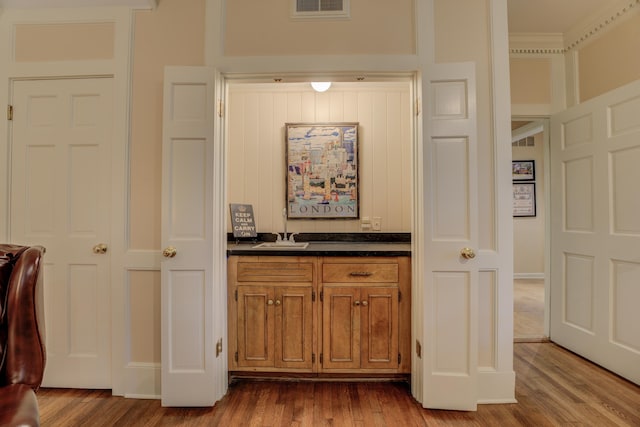 hallway with wood-type flooring and sink